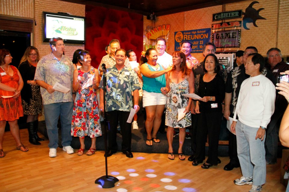 Class gathered around the mic to sing