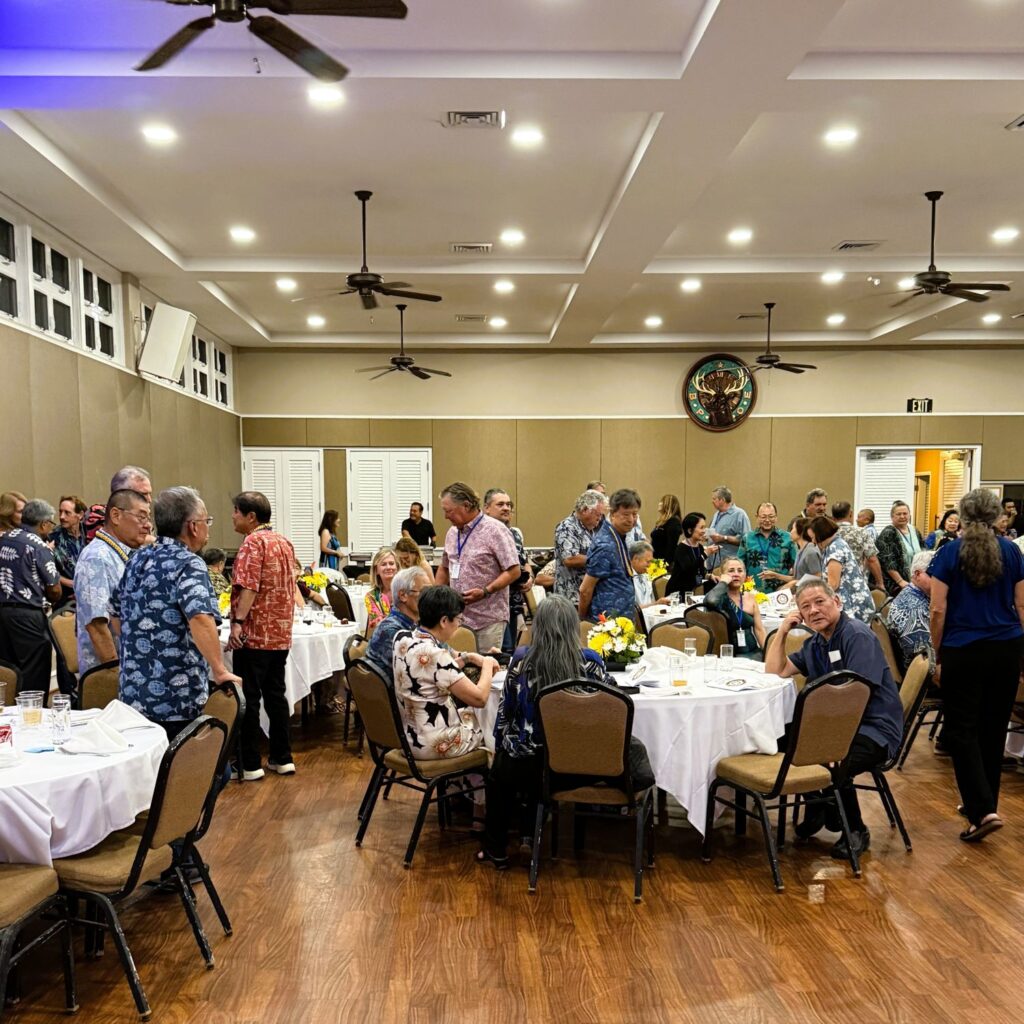 People mingling around banquet tables