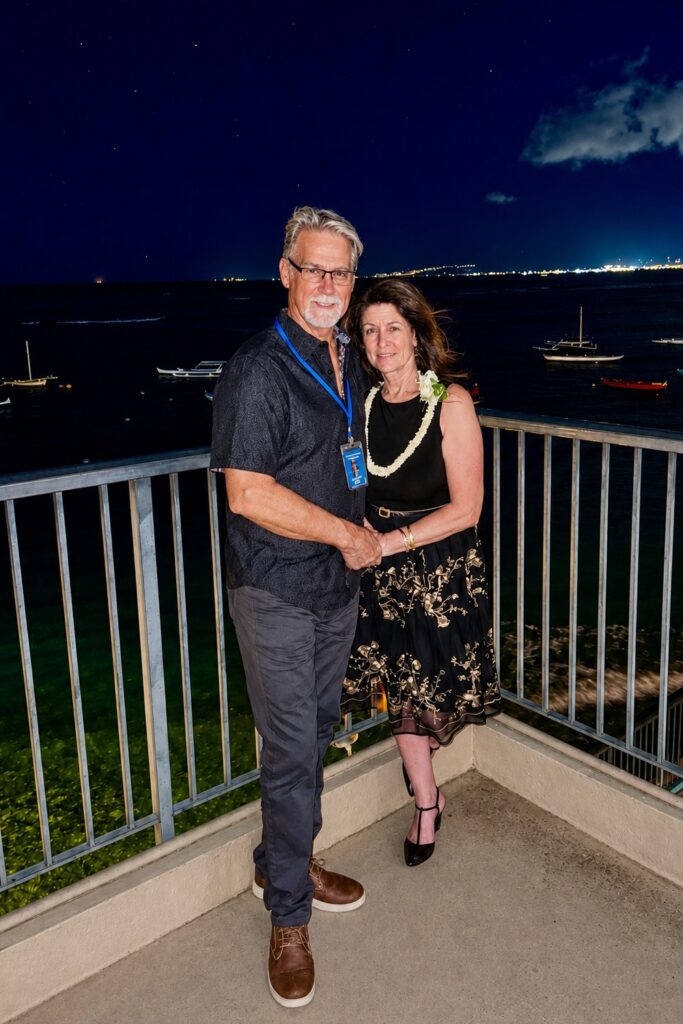 TimL and Kris with boats and city lights in the background